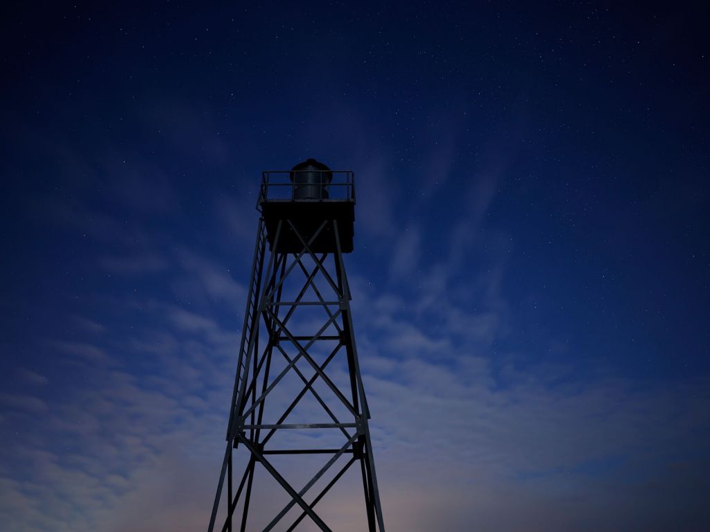 Phare dans la nuit étoilée