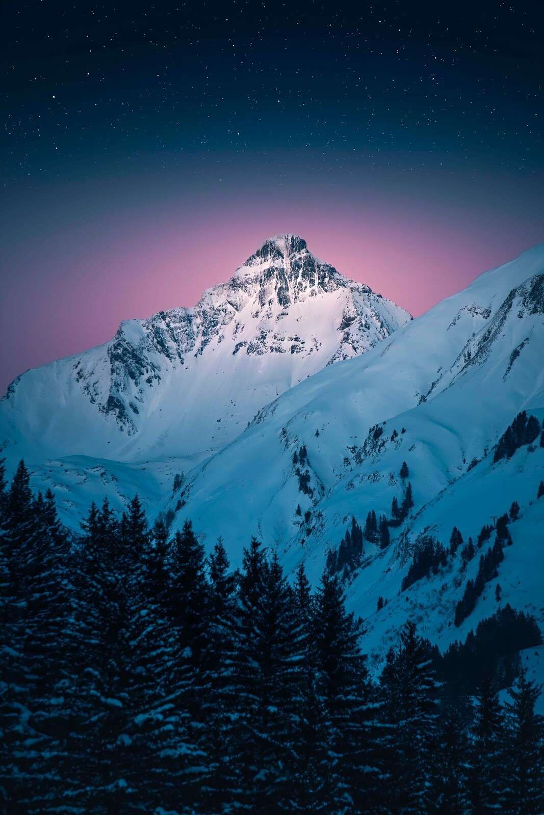Sommet enneigé sous une nuit étoilée